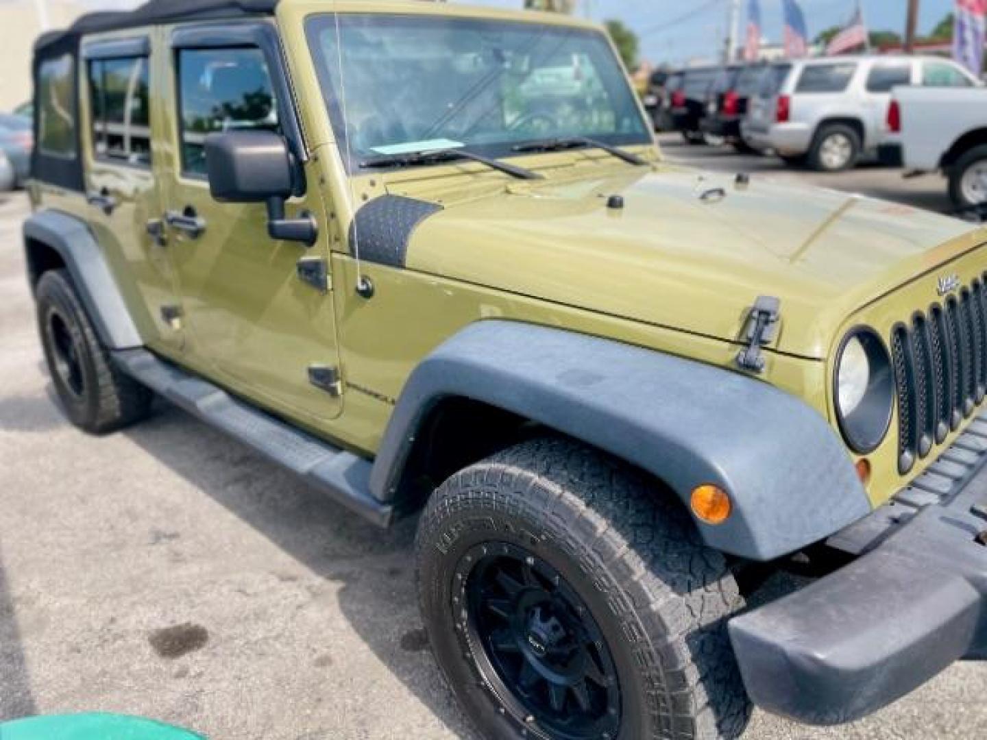 2013 OLIVE GREEN Jeep Wrangler Unlimited Sport 4WD (1C4BJWDG0DL) with an 3.6L V6 DOHC 24V FFV engine, located at 4545 Spencer Hwy., Pasadena, 77504, (832) 266-1645, 29.666037, -95.173775 - Photo#1