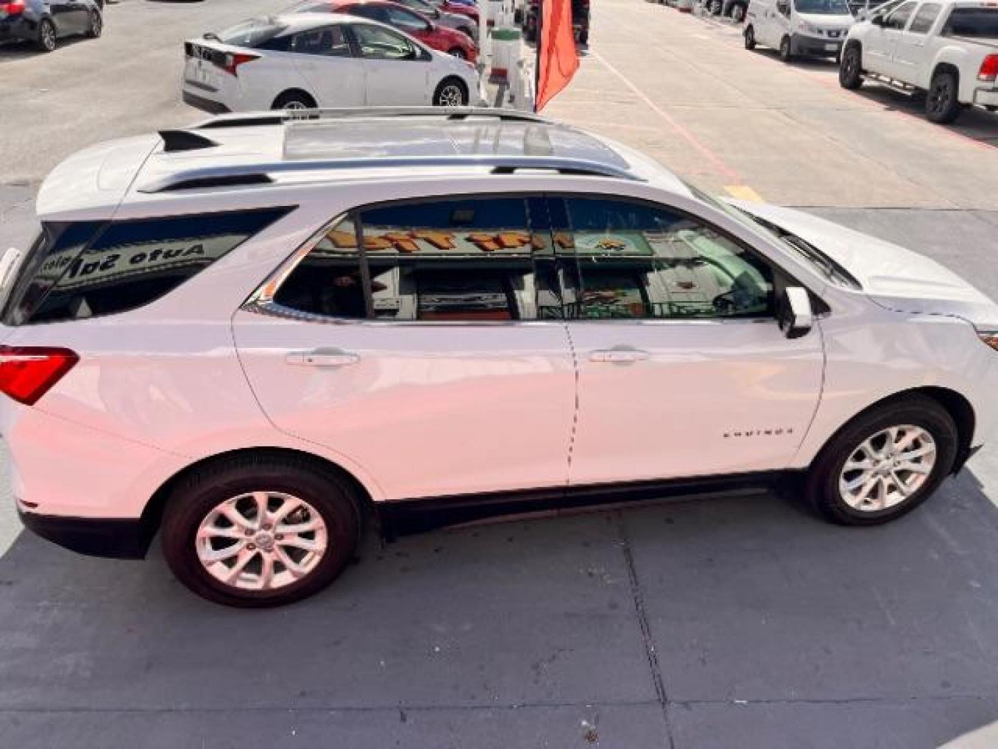 2018 Summit White /Medium Ash Gray Chevrolet Equinox LT (2GNAXJEV9J6) with an 1.5L I-4 gasoline direct injection engine, located at 4545 Spencer Hwy., Pasadena, 77504, (832) 266-1645, 29.666037, -95.173775 - Photo#3