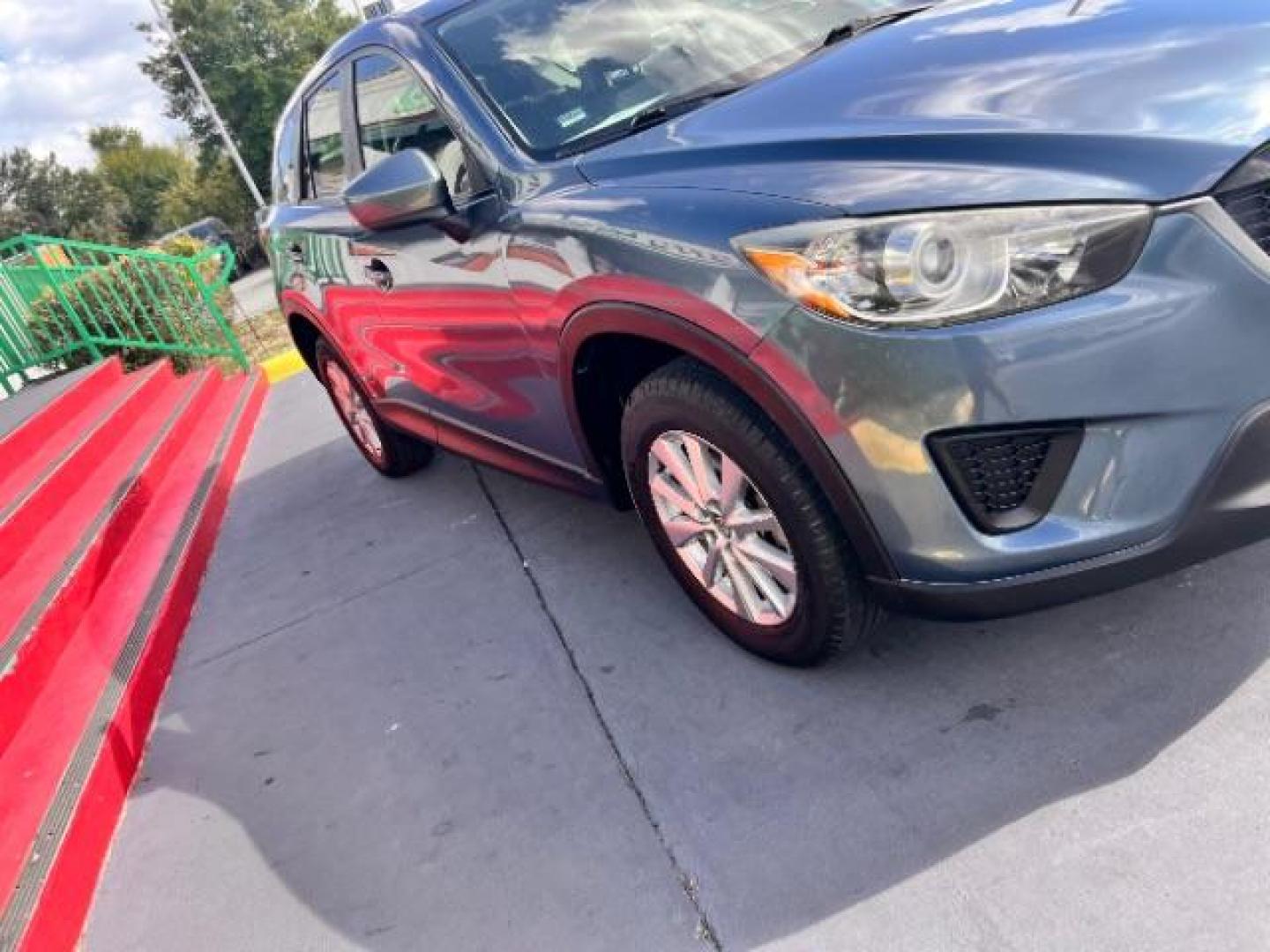 2014 Deep Crystal Blue Mica /Black Mazda CX-5 Sport (JM3KE2BE6E0) with an SKYACTIV-G 2L I-4 gasoline direct injection engine, located at 4545 Spencer Hwy., Pasadena, 77504, (832) 266-1645, 29.666037, -95.173775 - Photo#2