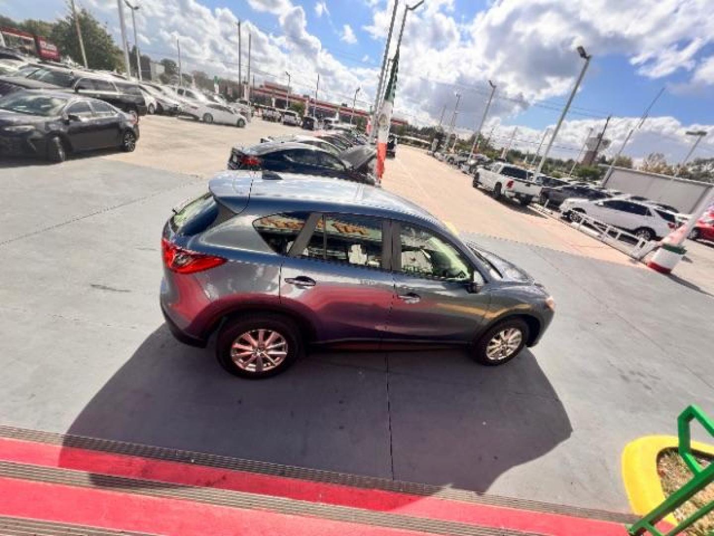 2014 Deep Crystal Blue Mica /Black Mazda CX-5 Sport (JM3KE2BE6E0) with an SKYACTIV-G 2L I-4 gasoline direct injection engine, located at 4545 Spencer Hwy., Pasadena, 77504, (832) 266-1645, 29.666037, -95.173775 - Photo#3