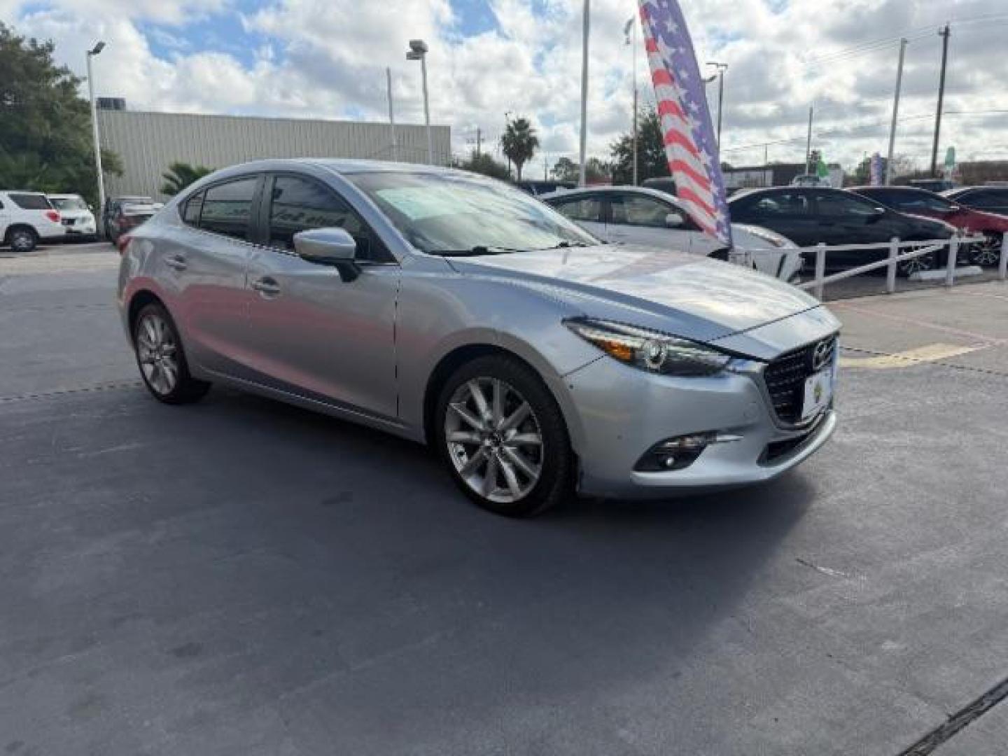 2017 Sonic Silver Metallic /Black Mazda Mazda3 Grand Touring (JM1BN1W32H1) with an SKYACTIV-G 2.5L I-4 gasoline direct injection engine, located at 4545 Spencer Hwy., Pasadena, 77504, (832) 266-1645, 29.666037, -95.173775 - Photo#2