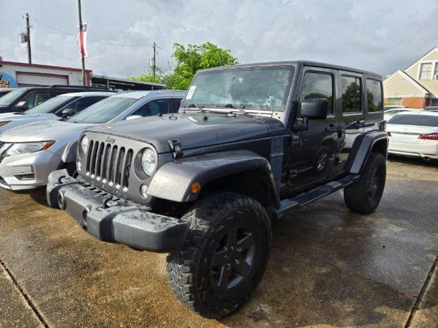 2016 Granite Crystal Metallic Clearcoat Jeep Wrangler Unlimited Freedom (1C4BJWDG6GL) with an Pentastar 3.6L V-6 DOHC engine, located at 7935 Gulf Freeway, Houston, 77017, (832) 266-1645, 29.684393, -95.275665 - Photo#0
