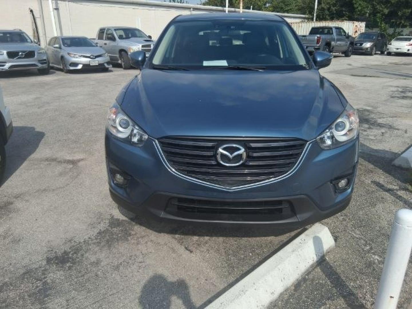 2016 Blue Reflex Mica Mazda CX-5 Grand Touring (JM3KE2DY7G0) with an SKYACTIV-G 2.5L I-4 gasoline direct injection engine, located at 4545 Spencer Hwy., Pasadena, 77504, (832) 266-1645, 29.666037, -95.173775- Photo#0