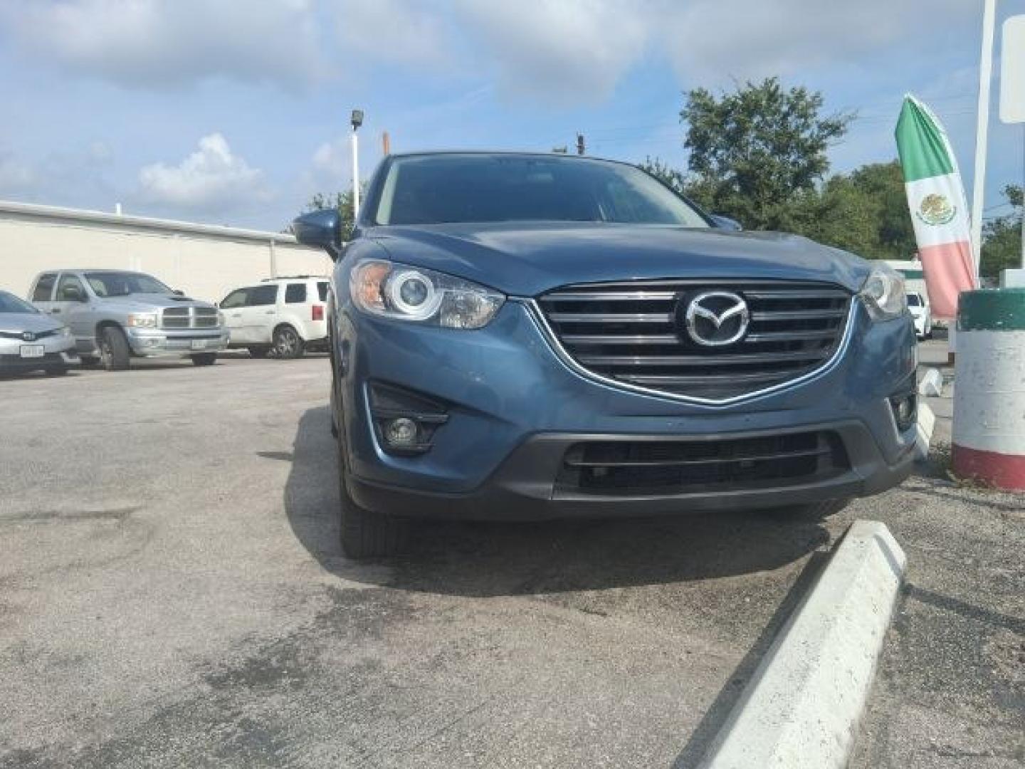 2016 Blue Reflex Mica Mazda CX-5 Grand Touring (JM3KE2DY7G0) with an SKYACTIV-G 2.5L I-4 gasoline direct injection engine, located at 4545 Spencer Hwy., Pasadena, 77504, (832) 266-1645, 29.666037, -95.173775- Photo#1