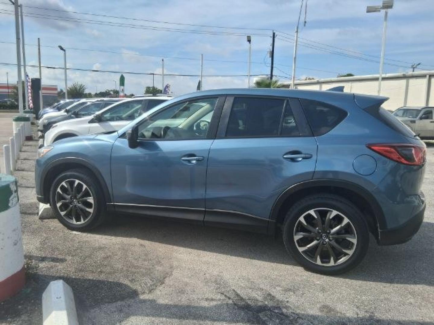 2016 Blue Reflex Mica Mazda CX-5 Grand Touring (JM3KE2DY7G0) with an SKYACTIV-G 2.5L I-4 gasoline direct injection engine, located at 4545 Spencer Hwy., Pasadena, 77504, (832) 266-1645, 29.666037, -95.173775- Photo#2