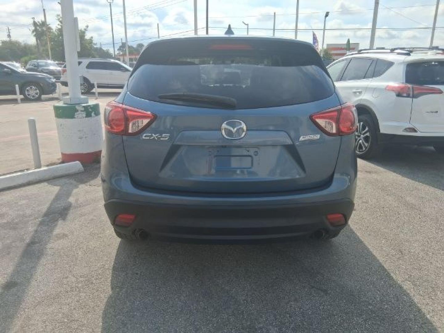 2016 Blue Reflex Mica Mazda CX-5 Grand Touring (JM3KE2DY7G0) with an SKYACTIV-G 2.5L I-4 gasoline direct injection engine, located at 4545 Spencer Hwy., Pasadena, 77504, (832) 266-1645, 29.666037, -95.173775- Photo#4